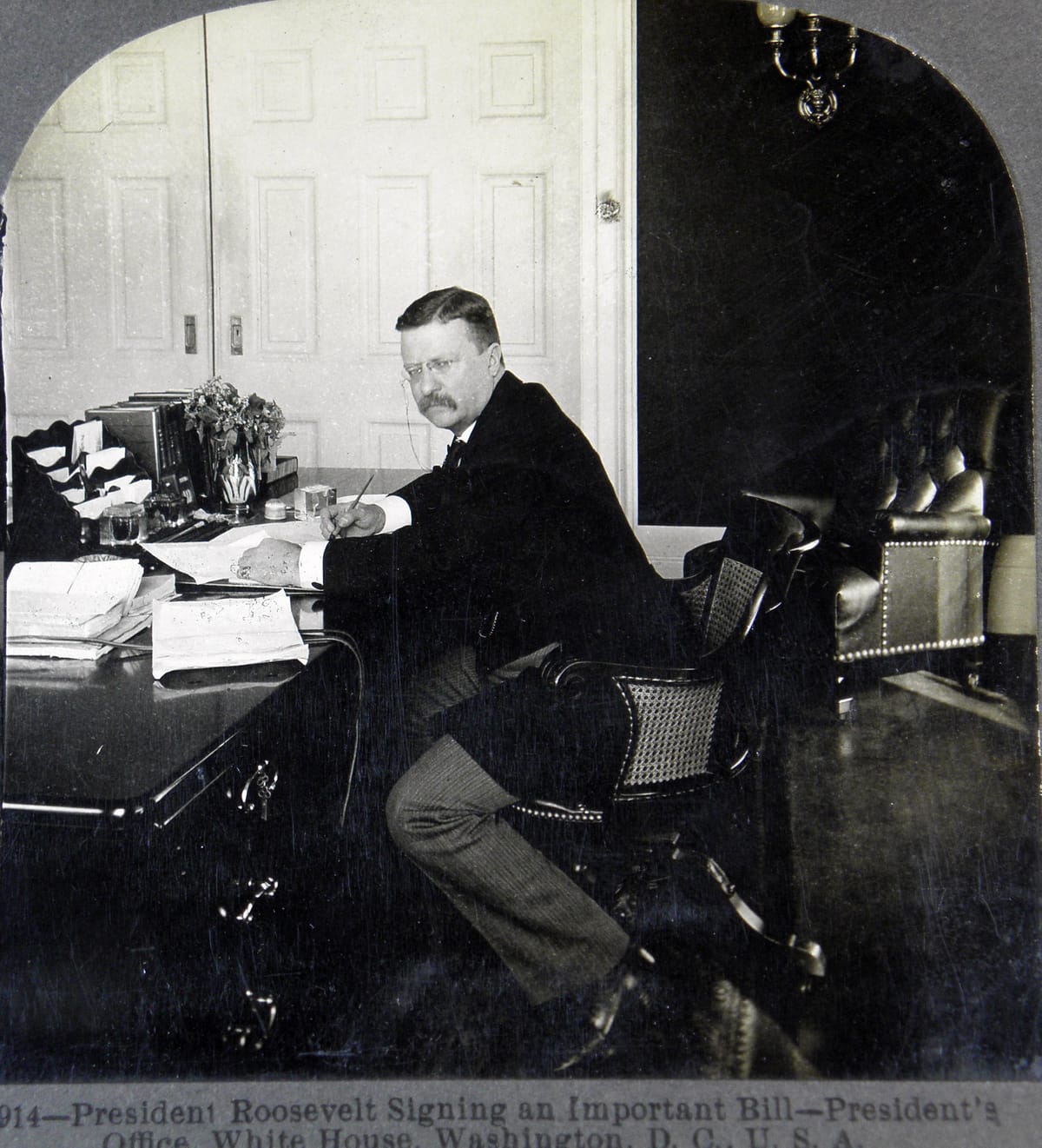 Picture of President Roosevelt captioned, "President Roosevelt Signing an Important Bill."