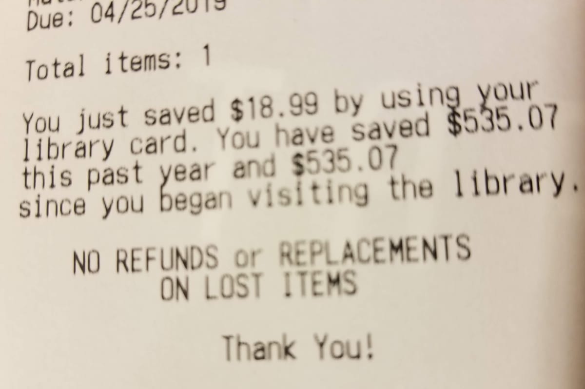 A receipt from a library saying, "You just saved $18.99 by using your library card."