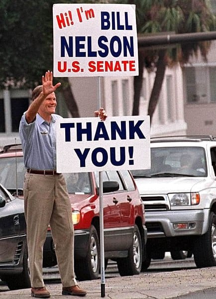 Senator Bill Nelson holding a 'Thank You!' sign. 