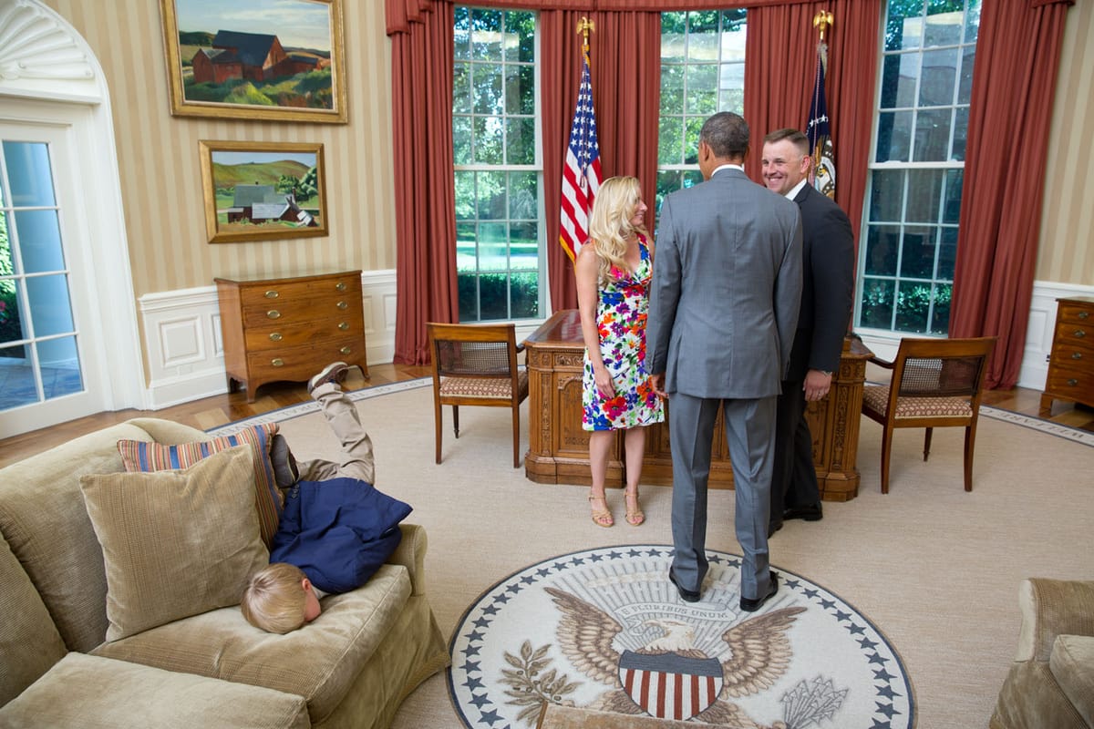 A kid does a faceplant behind President Obama in the Oval Office. 