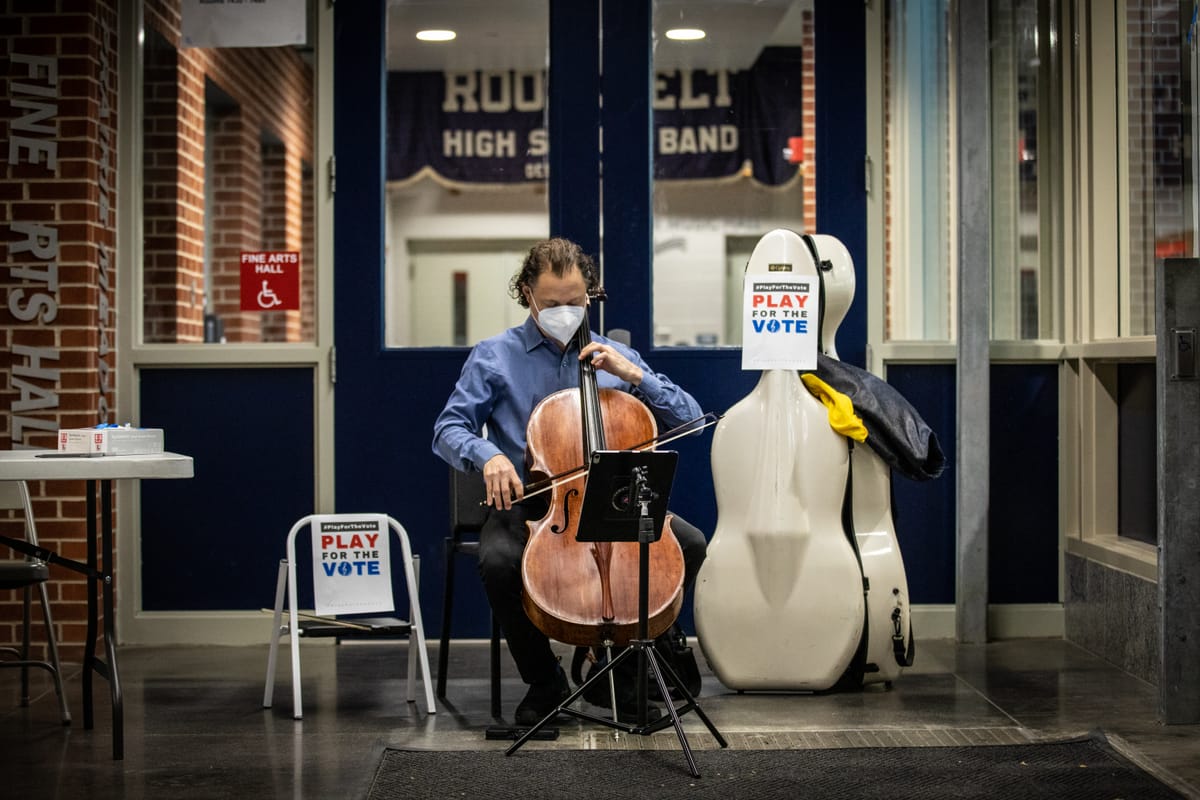 A man plays a cello outside a polling station in Des Moines. 